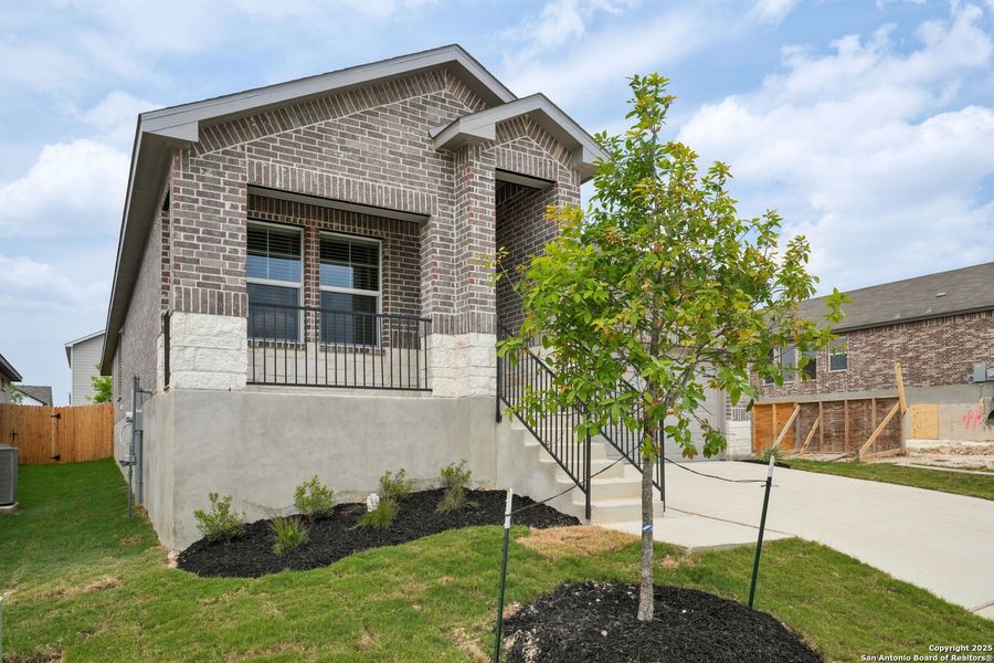 Front exterior of a new home in Thomas Pond, San Antonio, TX, highlighting curb appeal (Image 23). Front exterior of a new home in Thomas Pond, San Antonio, TX, highlighting curb appeal (Image 23).