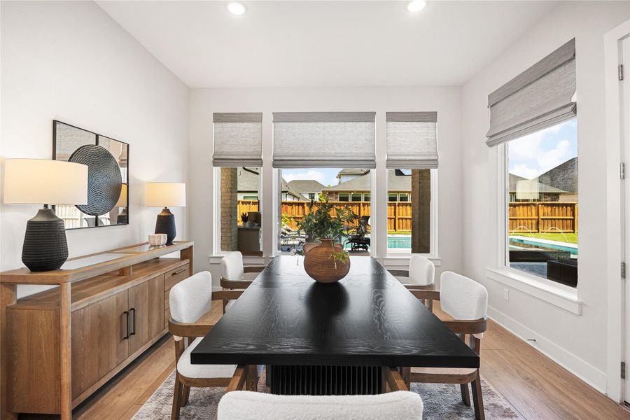The bright breakfast room sits just off the kitchen and offers beautiful views of the backyard oasis, making it the perfect spot to enjoy your morning coffee or casual meals.