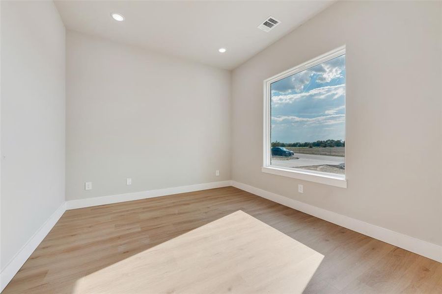 Spare room with wood-type flooring