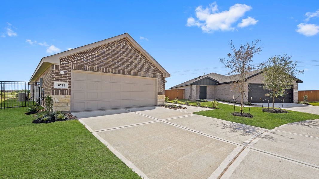Front exterior of a new home in Sunterra, Katy, TX, highlighting curb appeal (Image 18).