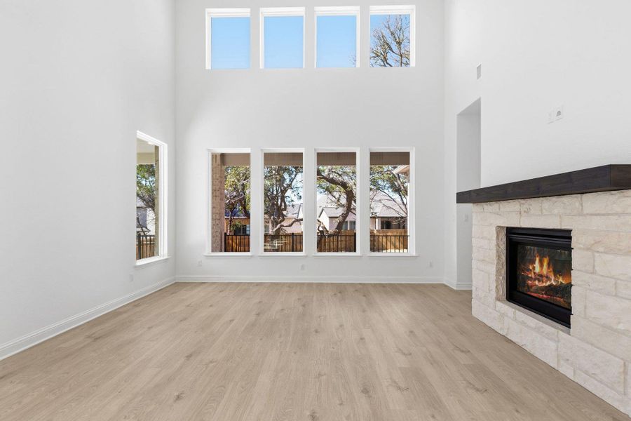 Family Room with soaring ceiling & fireplace