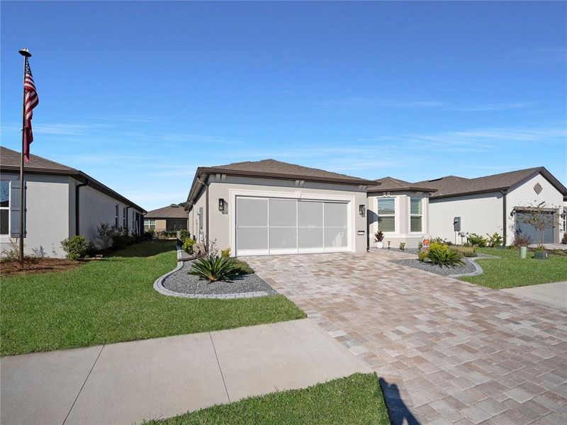 Front exterior of a new home in Del Webb Stone Creek, Ocala, FL, highlighting curb appeal (Image 2).