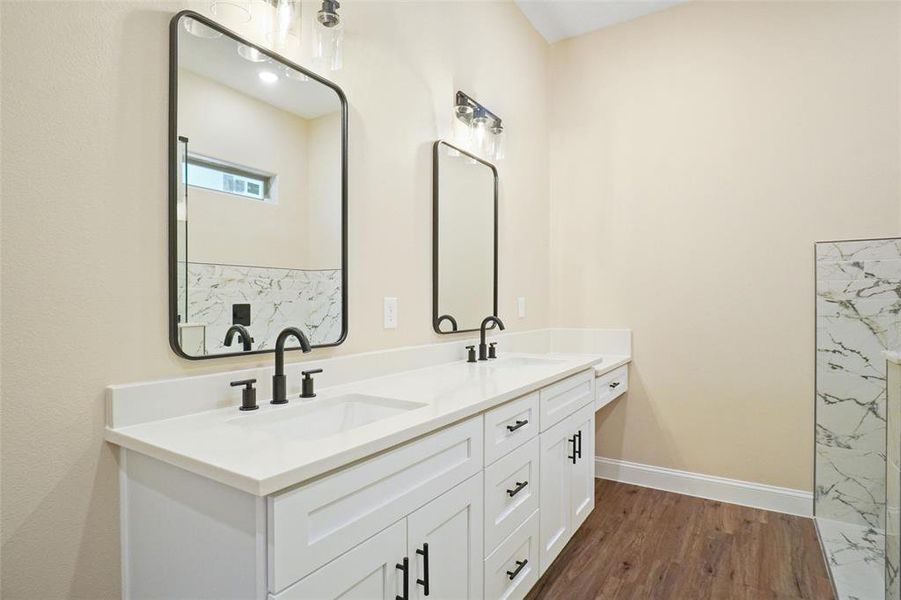 Bathroom featuring vanity and wood-type flooring