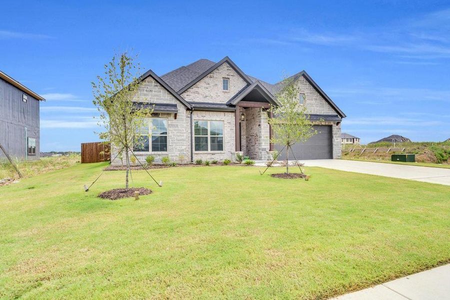 Front exterior of a new home in , Venus, TX, highlighting curb appeal (Image 20).