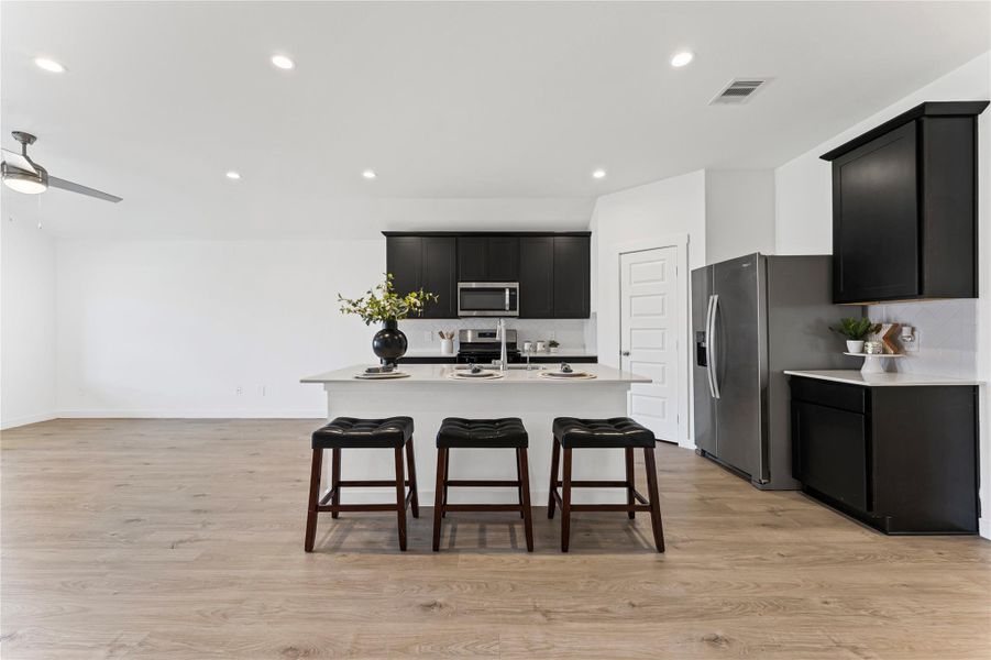 This chef’s dream features a massive center island that serves as the ultimate hub for meal prep and casual seating.