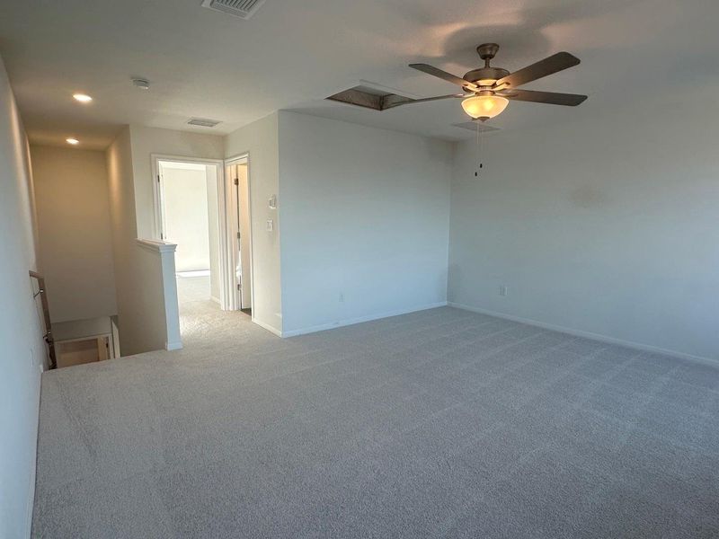 Carpeted empty room featuring a ceiling fan and recessed lighting Carpeted empty room featuring a ceiling fan and recessed lighting