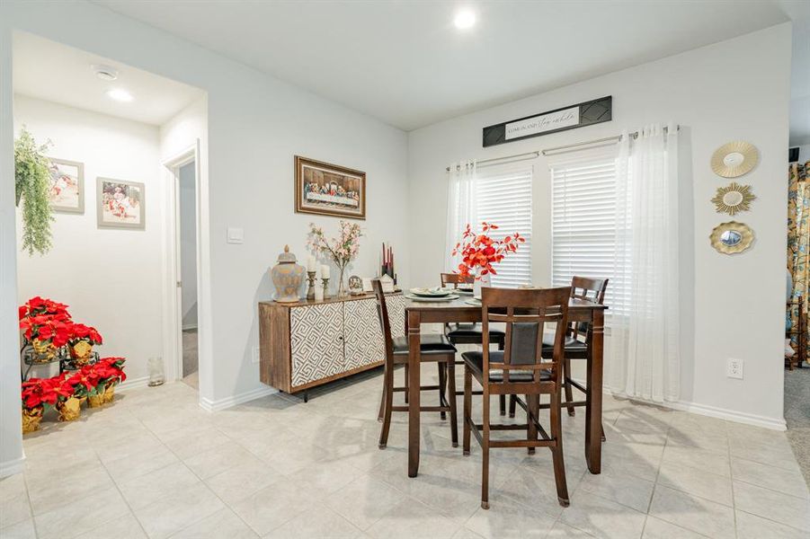 Dining room with light tile patterned floors and baseboards