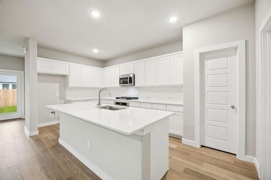 Kitchen in the Oscar home plan by Trophy Signature Homes – REPRESENTATIVE PHOTO