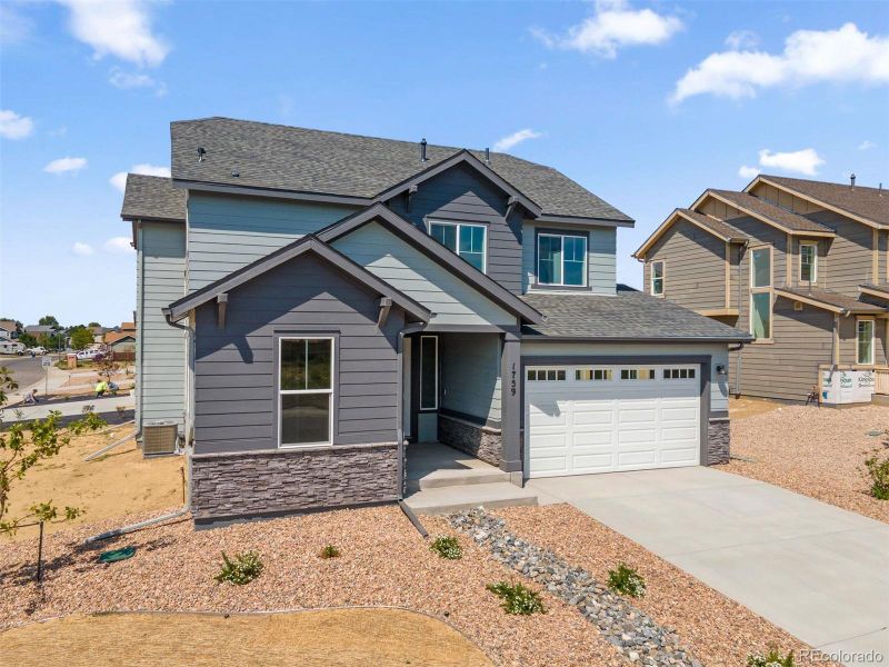 Front exterior of a new home in Cherry Meadows, Brighton, CO, highlighting curb appeal (Image 21). Front exterior of a new home in Cherry Meadows, Brighton, CO, highlighting curb appeal (Image 21).