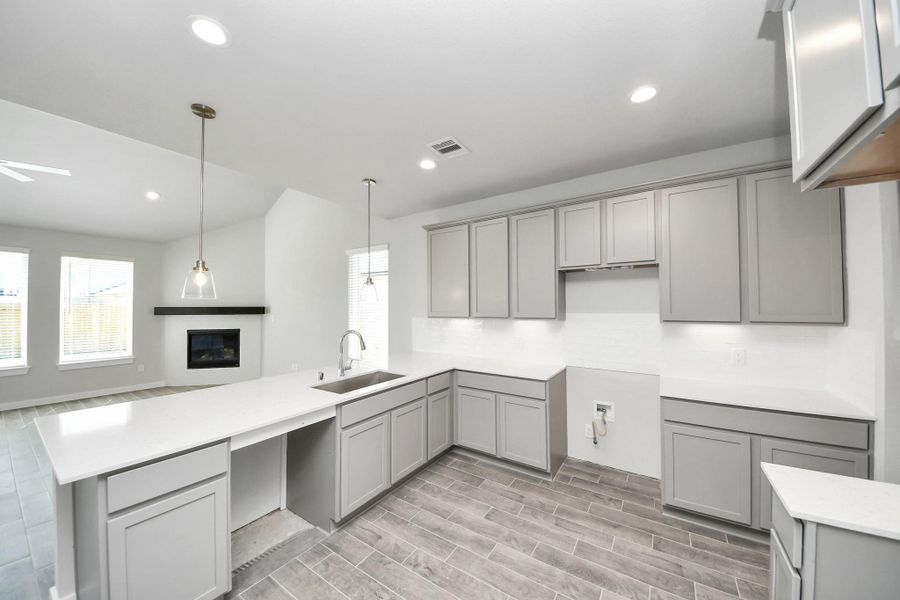 The extended counter area adds both practicality and style, making meal preparation a breeze. Every detail is thoughtfully designed to enhance the kitchen's functionality and aesthetic appeal. Sample photo of completed home with similar floor plan. Actual colors and selections may vary. The extended counter area adds both practicality and style, making meal preparation a breeze. Every detail is thoughtfully designed to enhance the kitchen's functionality and aesthetic appeal. Sample photo of completed home with similar floor plan. Actual colors and selections may vary.