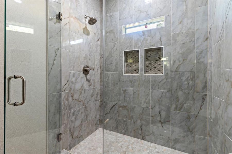 Full bathroom featuring a shower stall