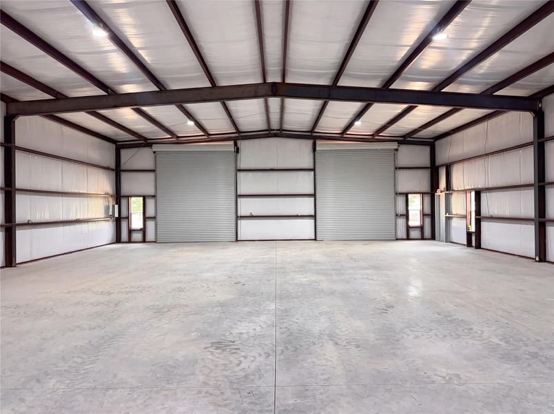 Soaring ceilings and concrete floors define this highly functional outbuilding space.