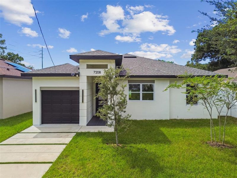 Front exterior of a new home in , Tampa, FL, highlighting curb appeal (Image 27).