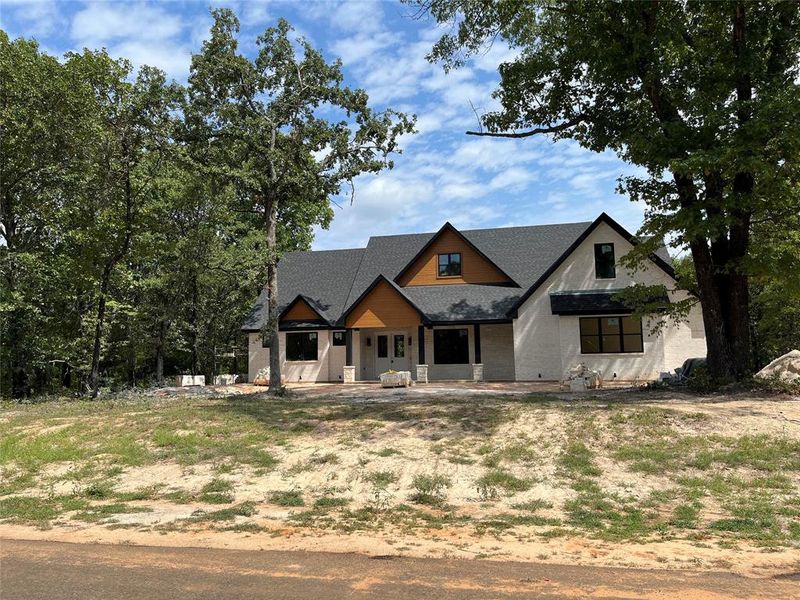 Modern brick farmhouse with covered porch and side-entry garage on almost one acre Modern brick farmhouse with covered porch and side-entry garage on almost one acre