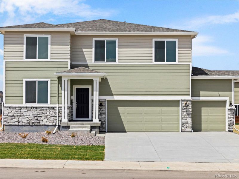 Front exterior of a new home in Revere at Johnstown, Johnstown, CO, highlighting curb appeal (Image 2).