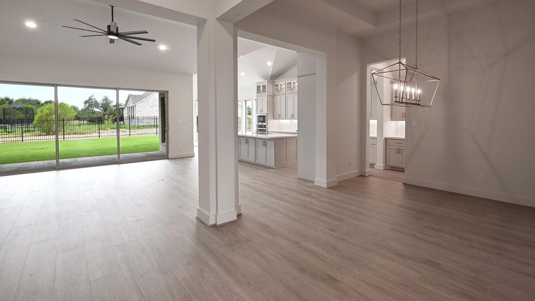 Unfurnished dining area featuring light wood-style flooring, a chandelier, recessed lighting, ceiling fan, and lofted ceiling