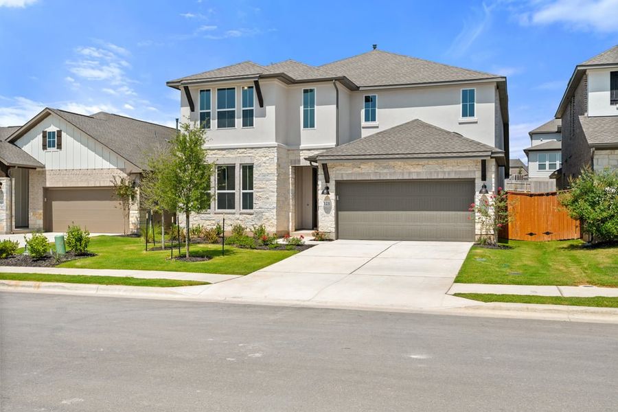 Front exterior of a new home in Park Collection at Lariat, Liberty Hill, TX, highlighting curb appeal (Image 22).