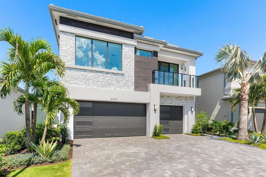 Front exterior of a new home in Lotus Edge, Boca Raton, FL, highlighting curb appeal (Image 21). Front exterior of a new home in Lotus Edge, Boca Raton, FL, highlighting curb appeal (Image 21).