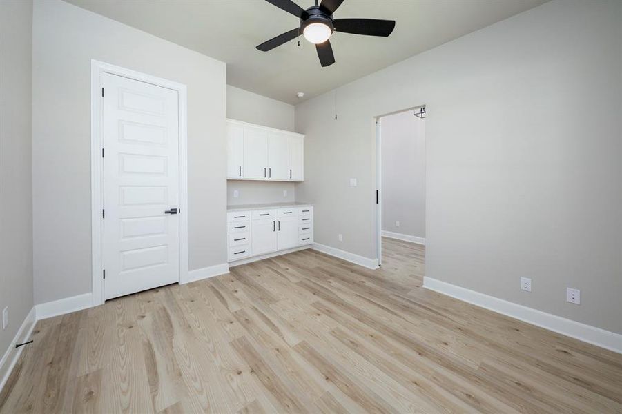 This spacious flex space has a beautiful barn door and built in cabinets.