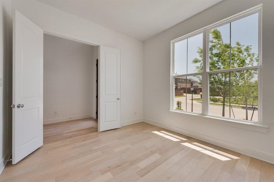 Unfurnished bedroom featuring light wood finished floors Unfurnished bedroom featuring light wood finished floors