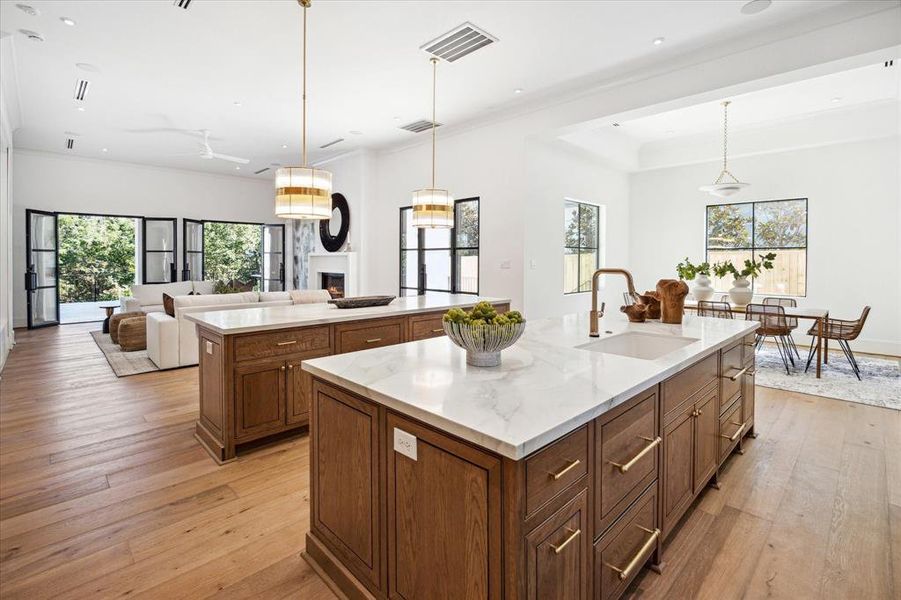 Equipped with premium SubZero Wolf appliances and gorgeous white oak cabinetry, this kitchen is designed for both functionality and beauty. The dual islands, topped with sleek Dekton quartz, provide plenty of space for entertaining and everyday living.