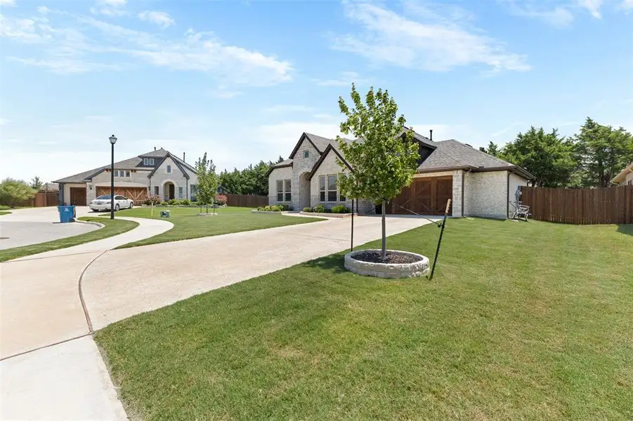 Exterior stone facade with dark trim accents and a prominent front entry Exterior stone facade with dark trim accents and a prominent front entry