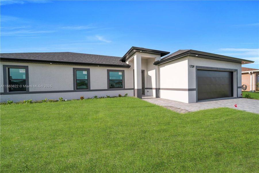 Front exterior of a new home in , Cape Coral, FL, highlighting curb appeal (Image 18). Front exterior of a new home in , Cape Coral, FL, highlighting curb appeal (Image 18).