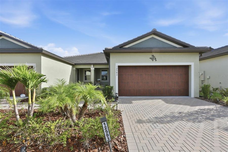 Front exterior of a new home in Prosperity Lakes Active Adult, Parrish, FL, highlighting curb appeal (Image 21).