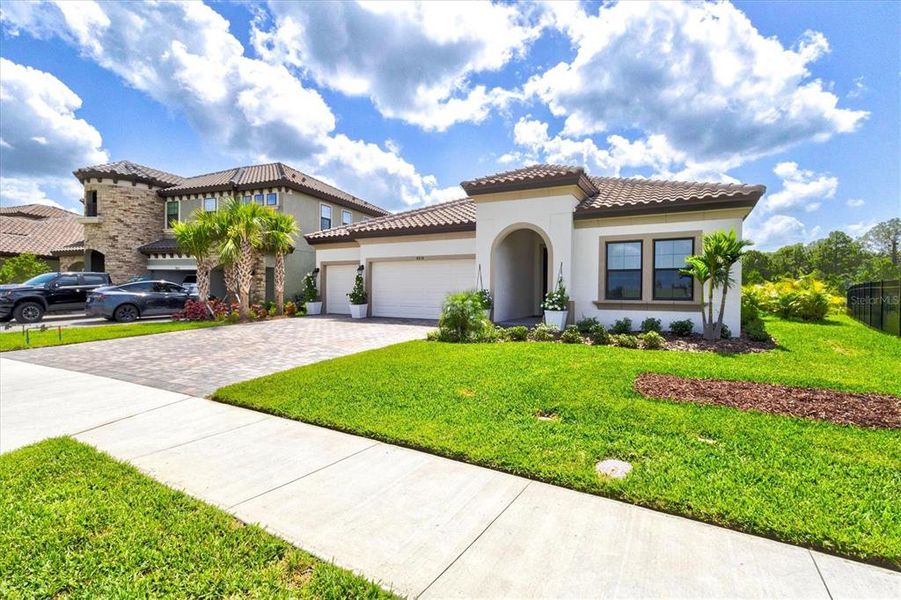Front exterior of a new home in Crosswind Ranch, Parrish, FL, highlighting curb appeal (Image 28).
