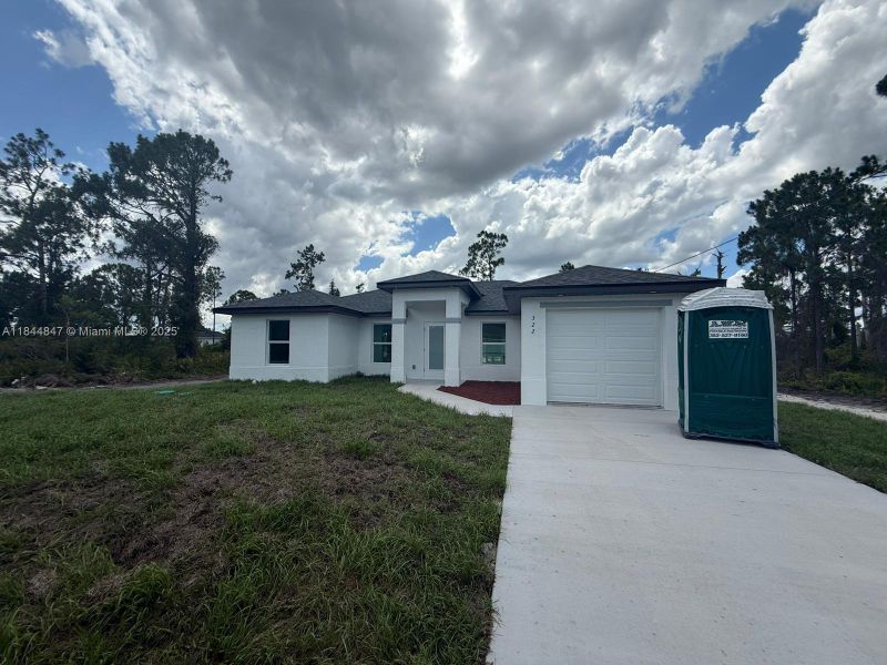 Front exterior of a new home in , Lehigh Acres, FL, highlighting curb appeal (Image 13). Front exterior of a new home in , Lehigh Acres, FL, highlighting curb appeal (Image 13).