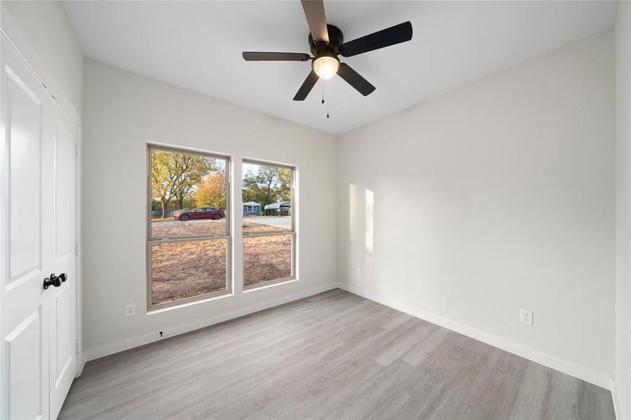 Spare room featuring light hardwood / wood-style flooring and ceiling fan