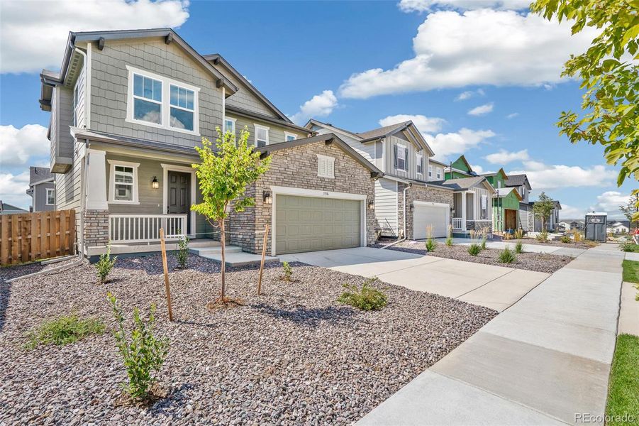 Front exterior of a new home in Turnberry, Commerce City, CO, highlighting curb appeal (Image 21).