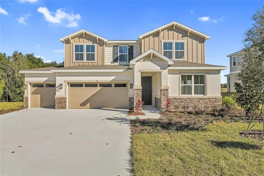 Front exterior of a new home in Seasons at Wekiva Ridge, Mount Dora, FL, highlighting curb appeal (Image 2). Front exterior of a new home in Seasons at Wekiva Ridge, Mount Dora, FL, highlighting curb appeal (Image 2).