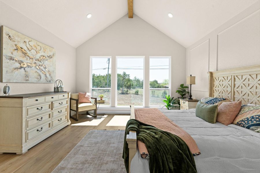 Bedroom with light wood-style flooring, beam ceiling, recessed lighting, and high vaulted ceiling Bedroom with light wood-style flooring, beam ceiling, recessed lighting, and high vaulted ceiling