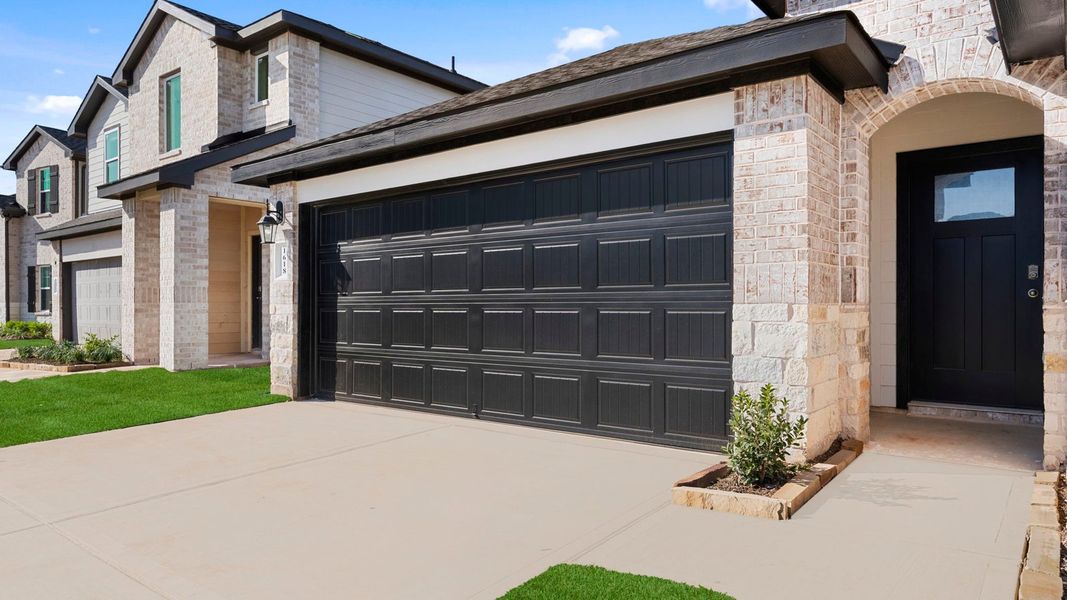 Front exterior of a new home in Tamarron, Fulshear, TX, highlighting curb appeal (Image 2). Front exterior of a new home in Tamarron, Fulshear, TX, highlighting curb appeal (Image 2).