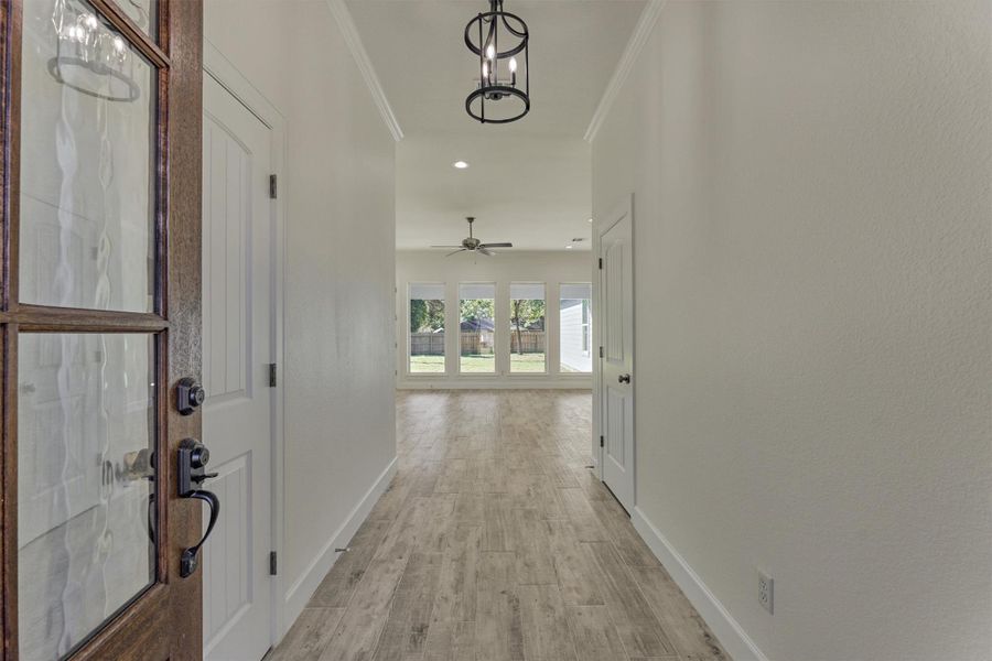 Step inside to continuous wood-look tile flooring throughout and beautiful sightlines into the expansive, private backyard. Step inside to continuous wood-look tile flooring throughout and beautiful sightlines into the expansive, private backyard.