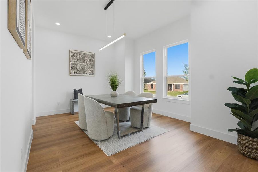 Dining space featuring wood finished floors and recessed lighting