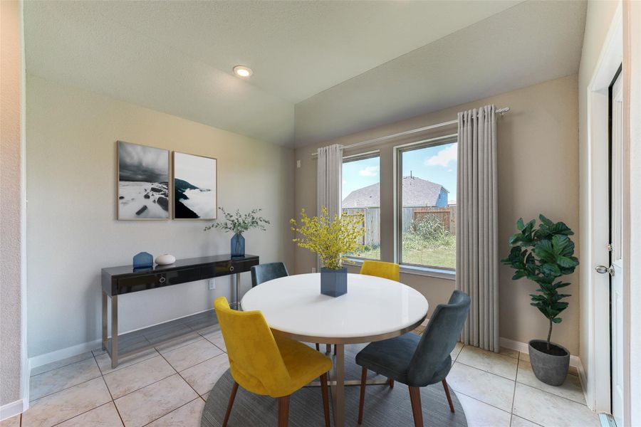 Make memories gathered around the table with your family and friends! This spacious dining room features elegant flooring, custom paint, and adjacent to family room and kitchen for open concept feel. Sample photo of completed home with similar floor plan. As-built interior colors and selections may vary.