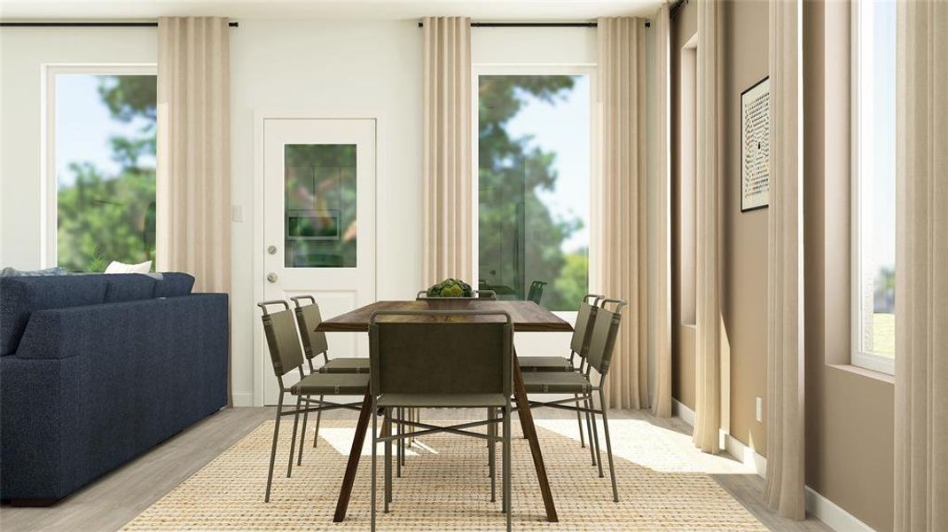Dining room with plenty of natural light and light wood-style flooring