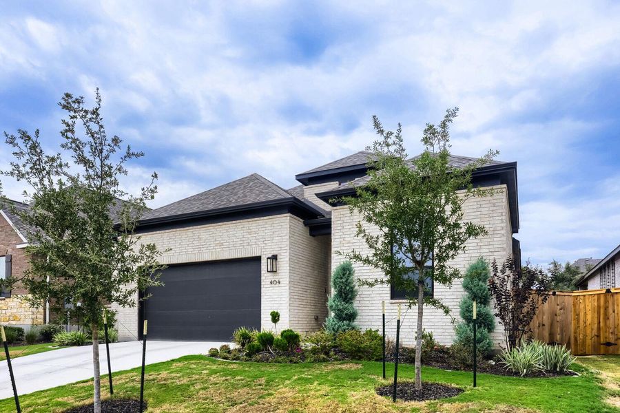 Front exterior of a new home in 6 Creeks at Waterridge, Kyle, TX, highlighting curb appeal (Image 28).