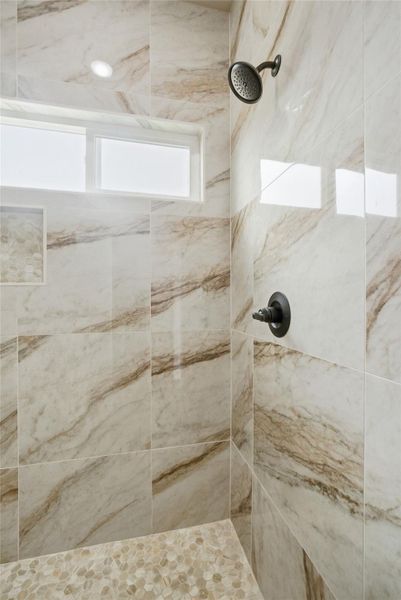 Full bathroom featuring tiled shower