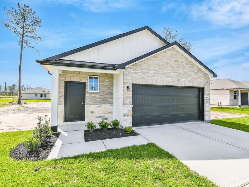 Front exterior of a new home in Spring Branch Crossing, Conroe, TX, highlighting curb appeal (Image 2).