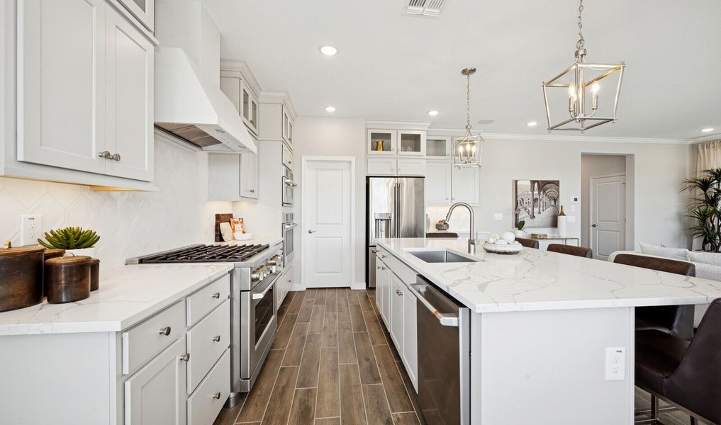 Kitchen with glass upper cabinets and pendant lighting