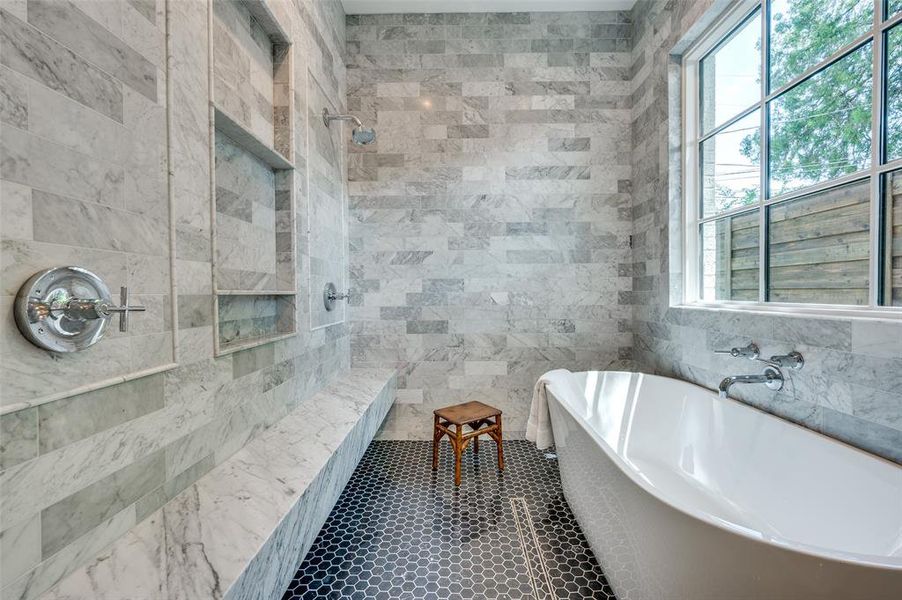 Primary bathroom with tile walls, a soaking tub, and a tile shower Primary bathroom with tile walls, a soaking tub, and a tile shower