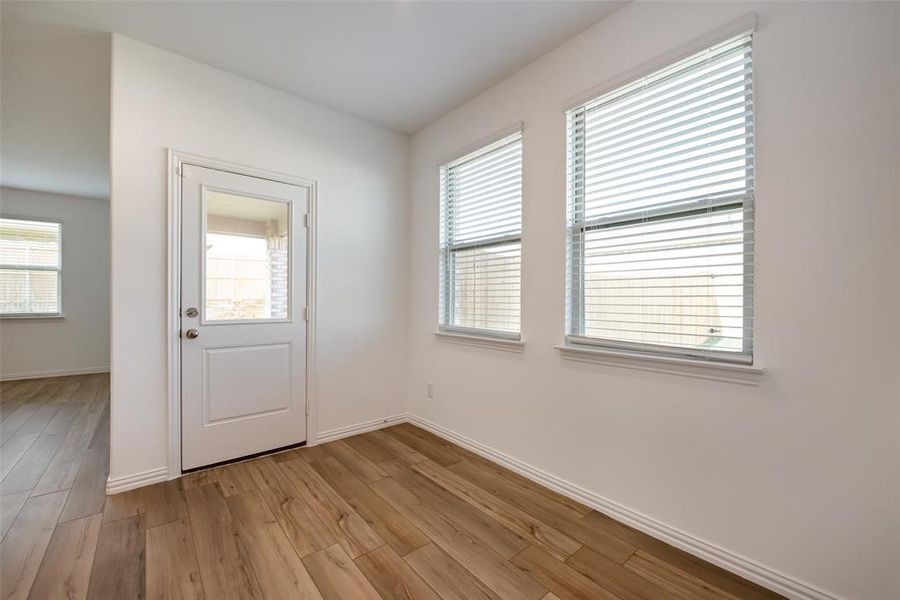 Doorway to outside with wood-type flooring