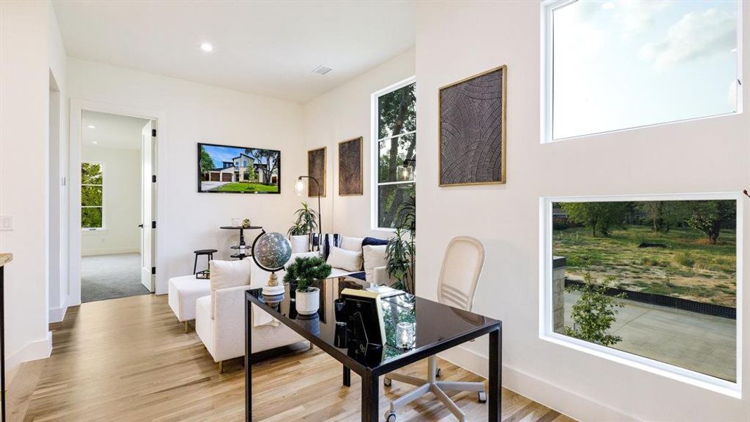 Office with light hardwood / wood-style flooring