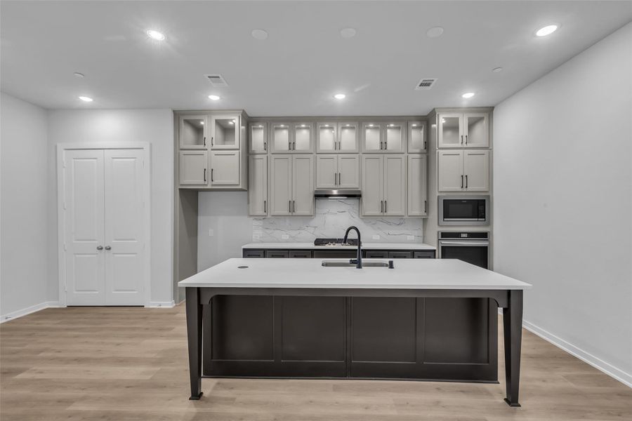 Kitchen features a large island with additional seating.