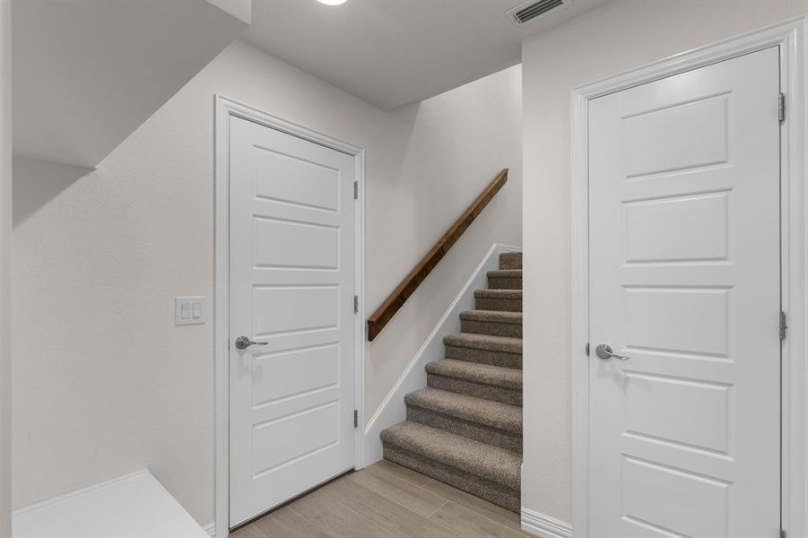 Staircase with wood tiled floors and baseboards Staircase with wood tiled floors and baseboards