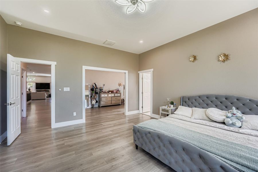 Bedroom with light wood-style flooring and recessed lighting Bedroom with light wood-style flooring and recessed lighting