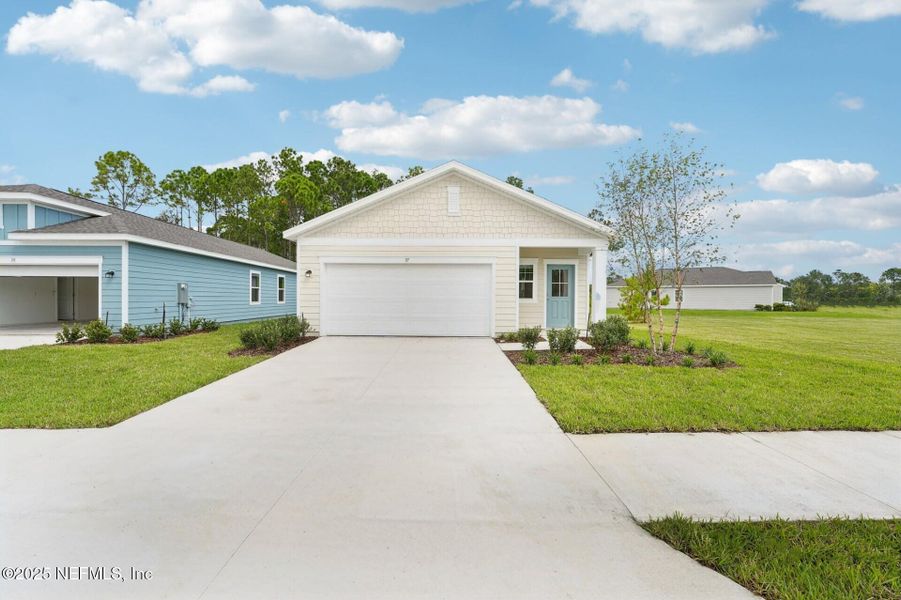 Front exterior of a new home in , Palm Coast, FL, highlighting curb appeal (Image 1). Front exterior of a new home in , Palm Coast, FL, highlighting curb appeal (Image 1).